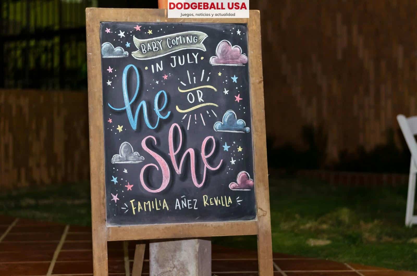 brown framed chalkboard easel with baby coming in July he or she text