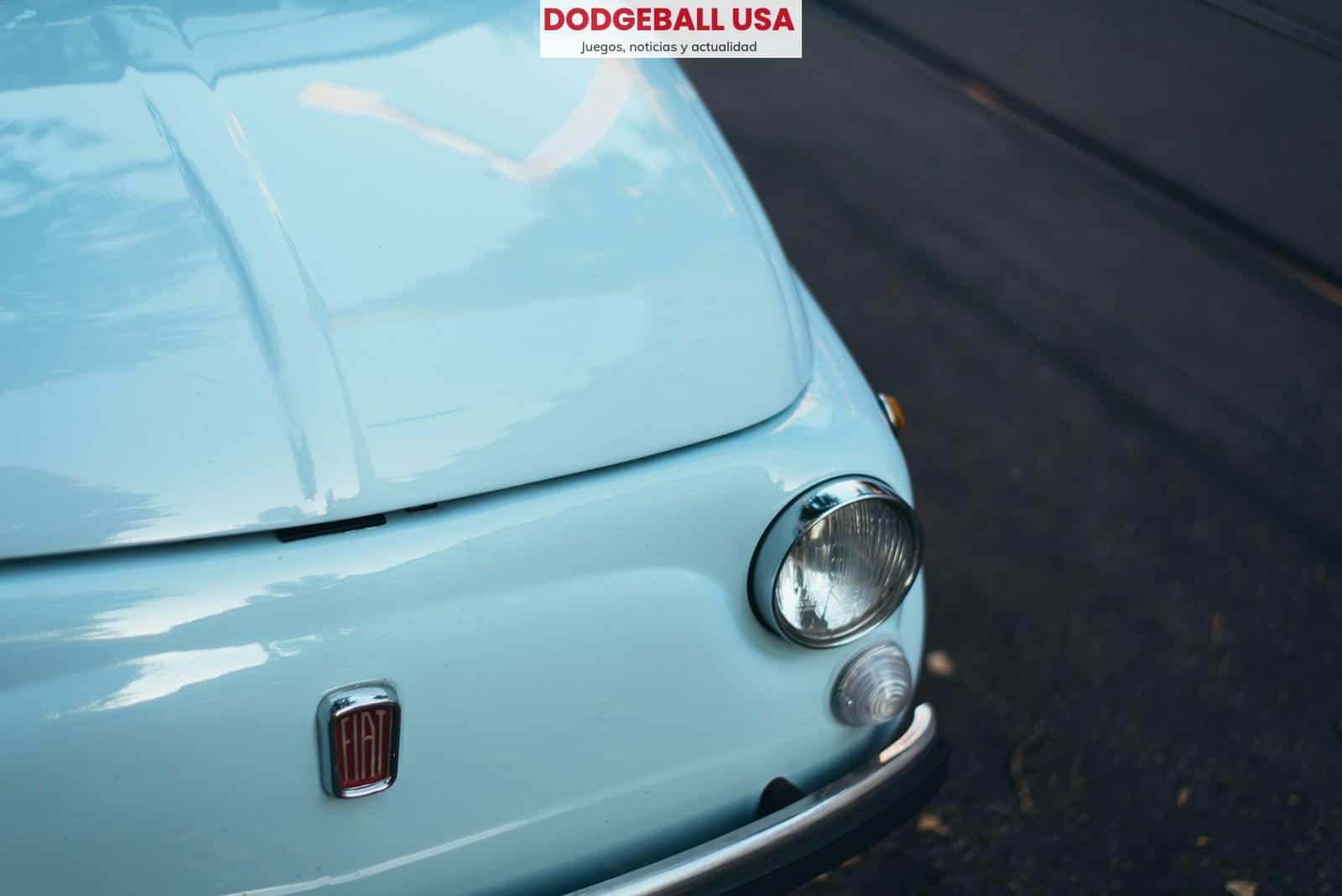 white FIAT car parked on asphalt road